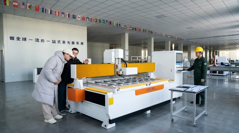 Customers inspecting a large-format laser cutting machine