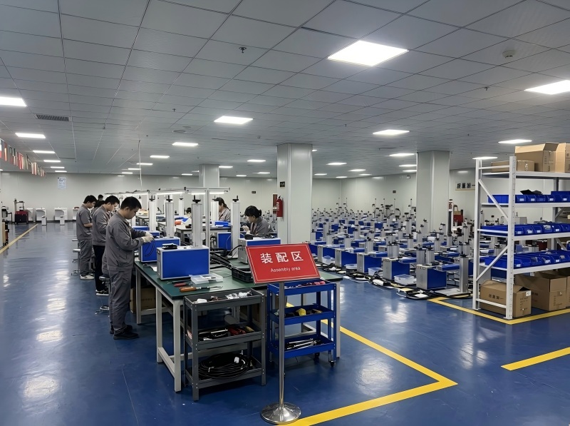 Workers assembling fiber laser marking machines on the production line