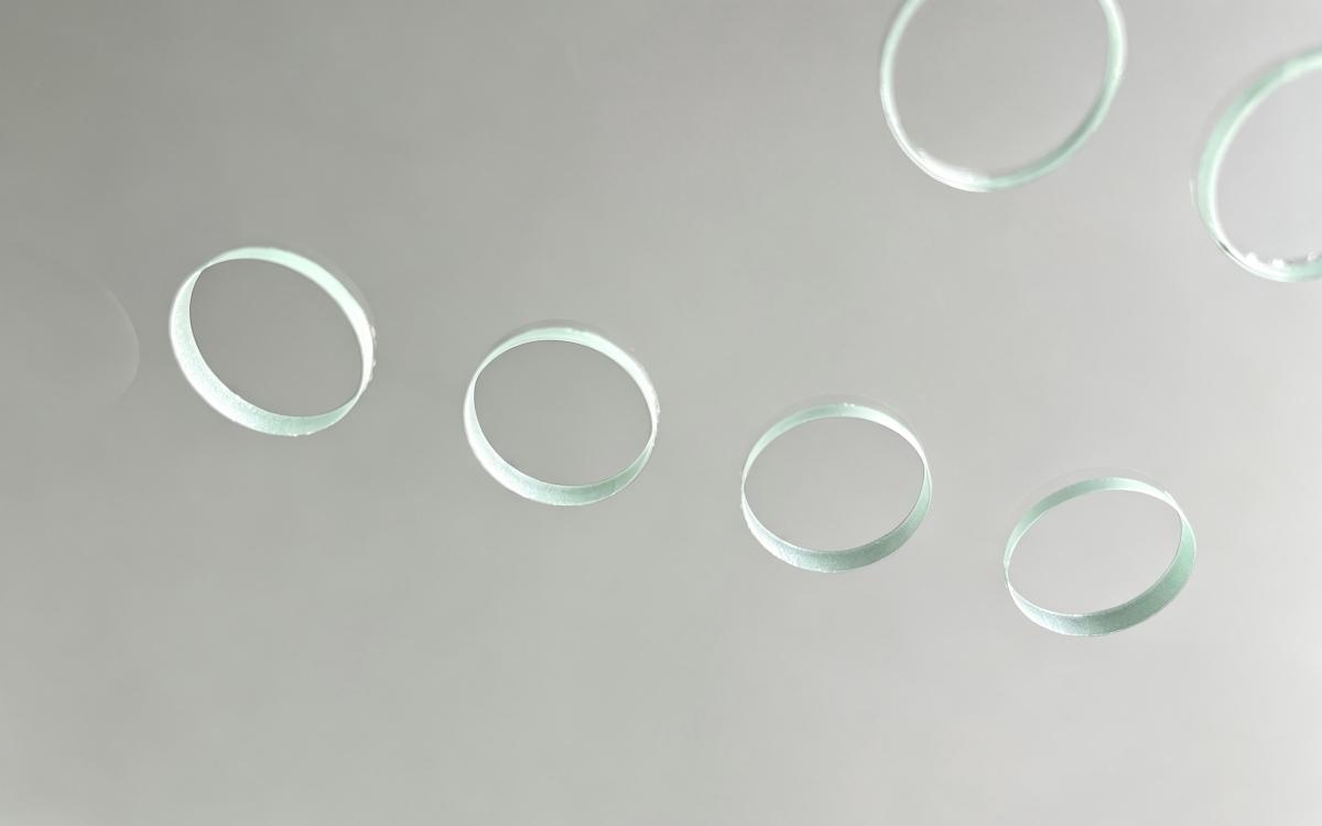 Round holes and slots made in clear glass by laser