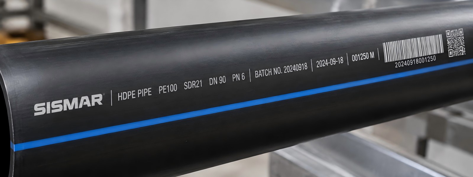 Close-up of laser-marked date and batch code on HDPE pipe surface